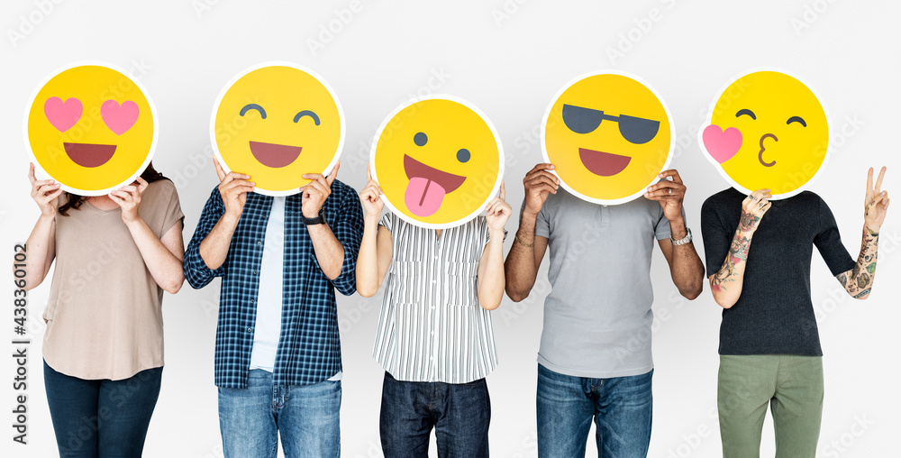 Diverse people holding happy emoticons