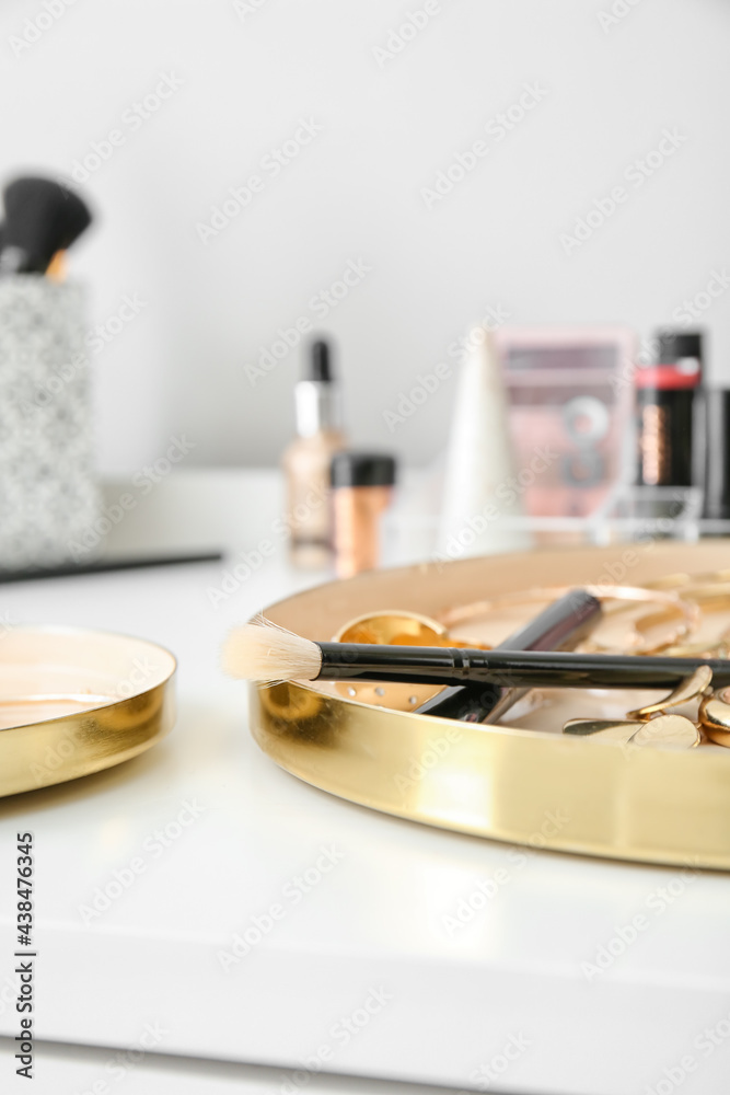 Makeup brushes and accessories on table, closeup