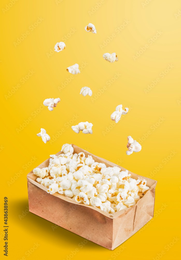 Popcorn falling into a pot on a yellow background. June Celebration