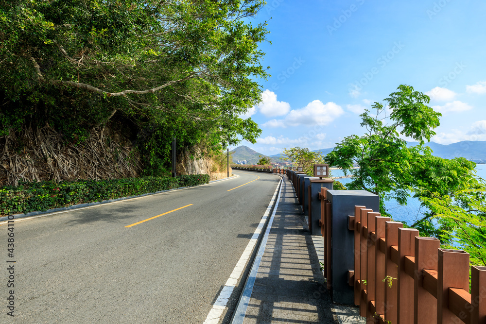 Empty asphalt road and mountain scenery on sunny day.