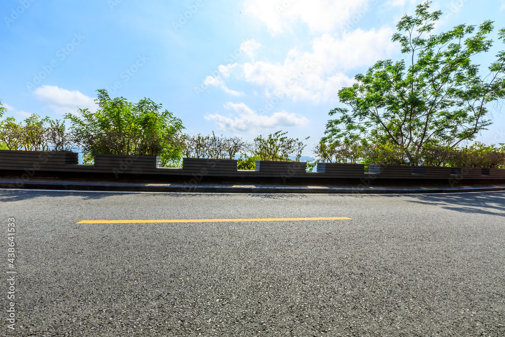 Empty asphalt road and mountain scenery on sunny day.