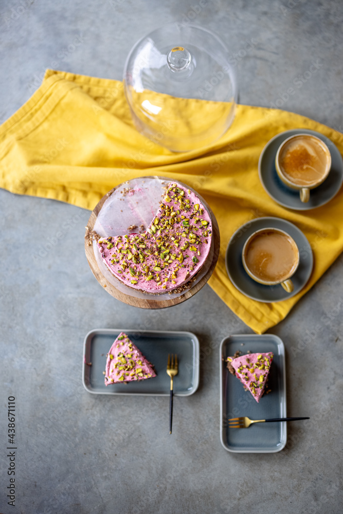 Nut strawberry cheesecake and coffee drinks on the concrete background with yellow tablecloth, view 