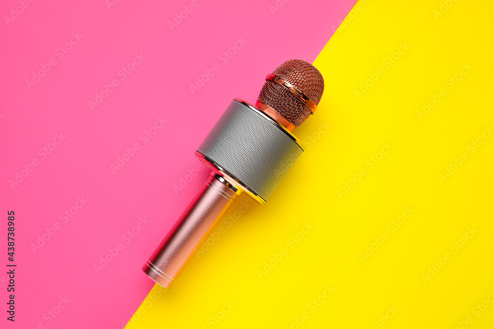 Modern microphone on color background