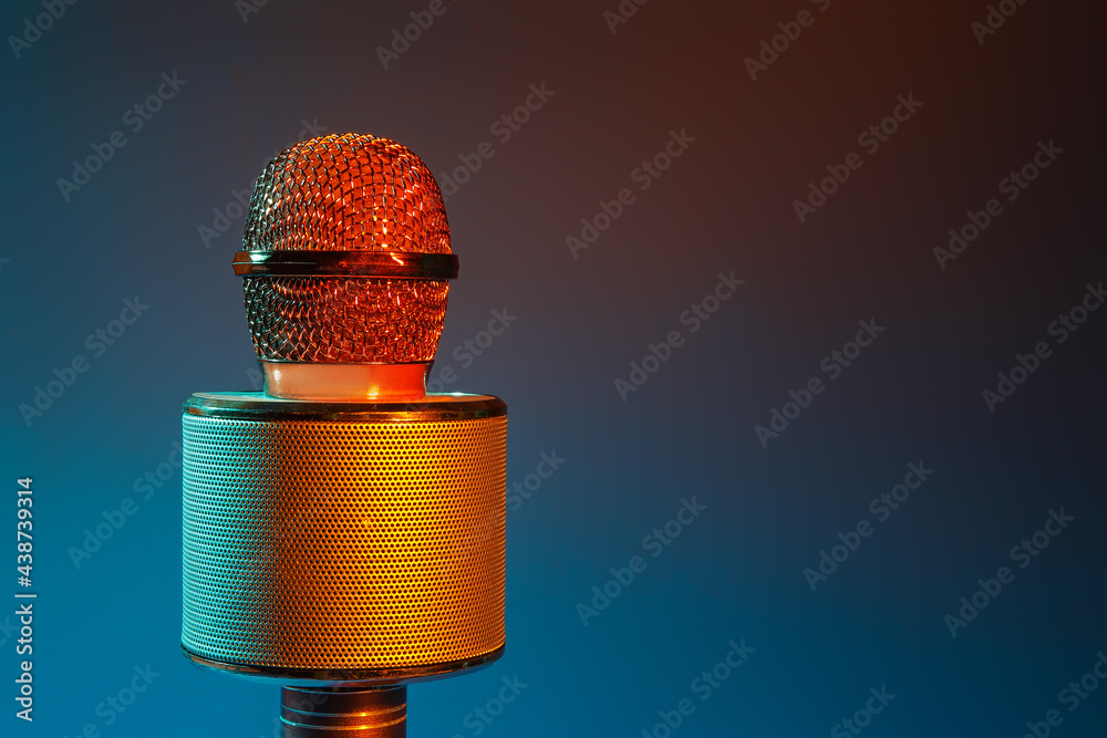 Modern microphone on dark color background, closeup