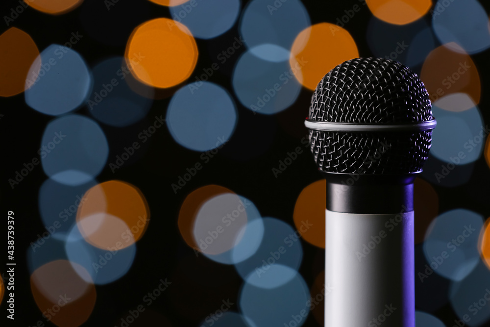 Modern microphone against defocused lights, closeup