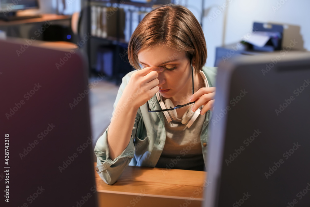 Tired female programmer working in office at night