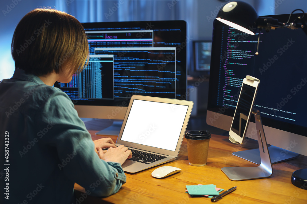 Female programmer working in office at night