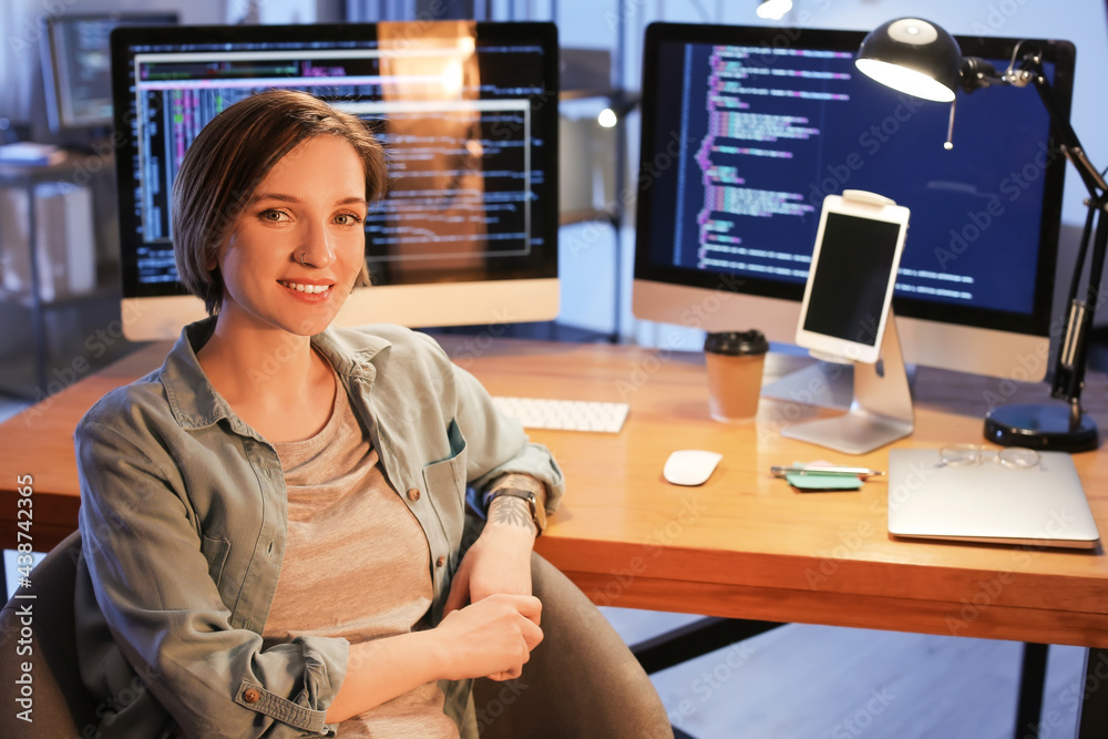 Female programmer working in office at night