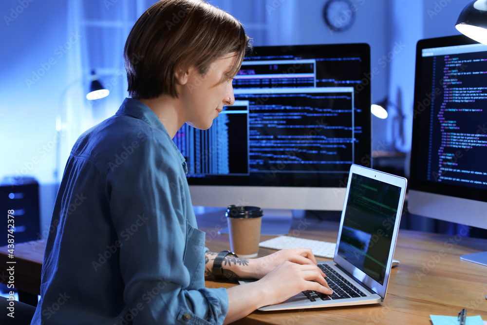 Female programmer working in office at night