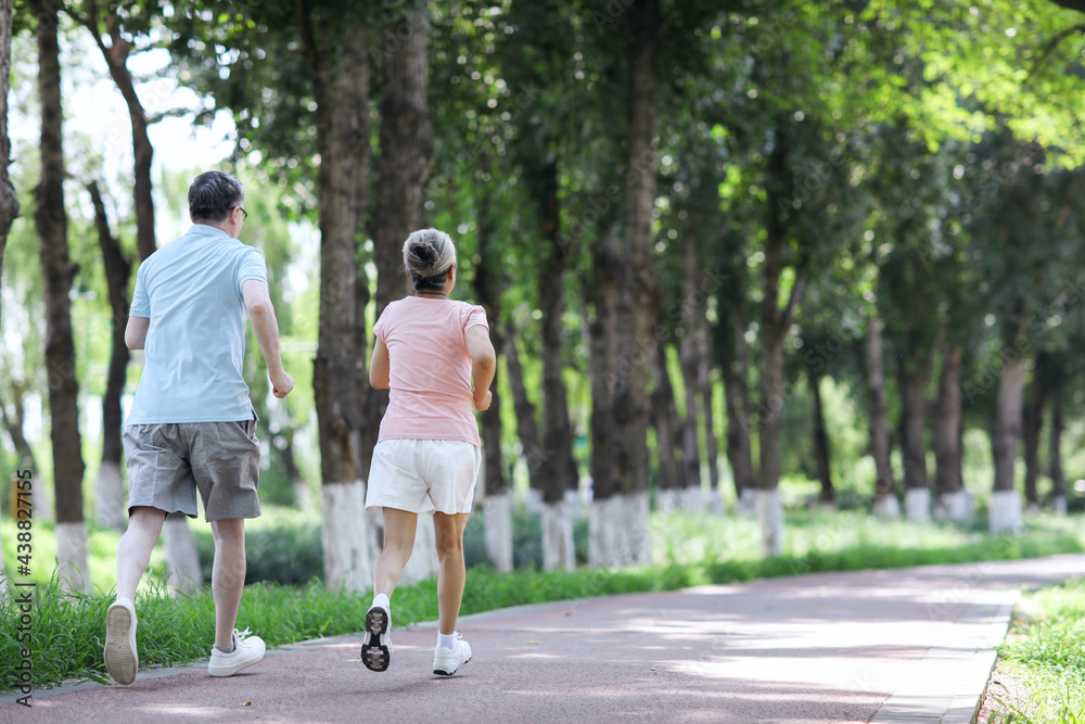 Old couple jogging in outdoor park