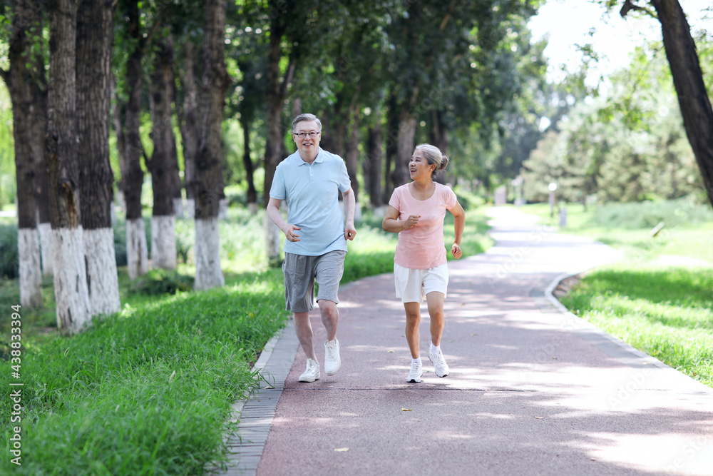 Old couple jogging in outdoor park