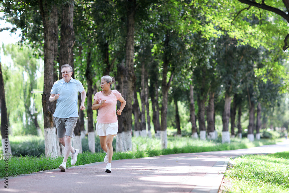 Old couple jogging in outdoor park