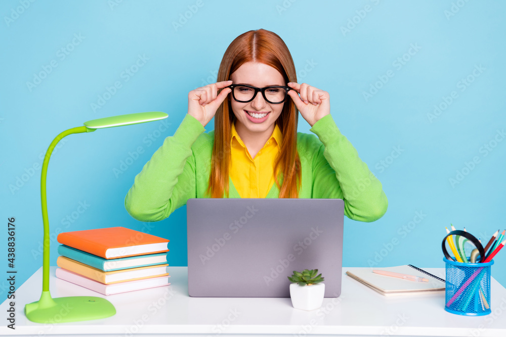 Photo of young sweet ginger lady work from home hands spectacles wear green sweater isolated on blue