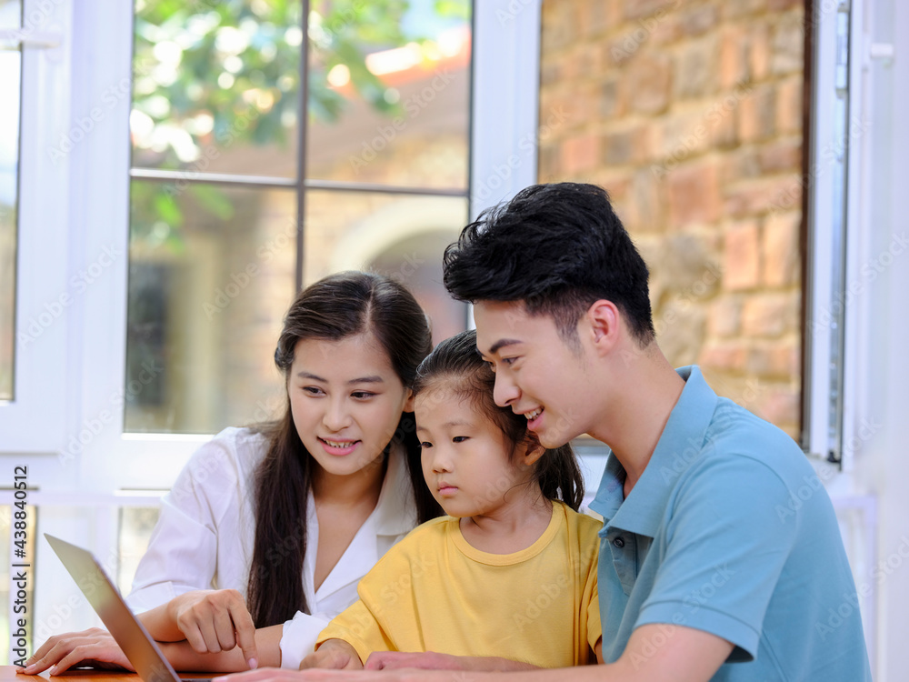 A Happy family of three using laptop