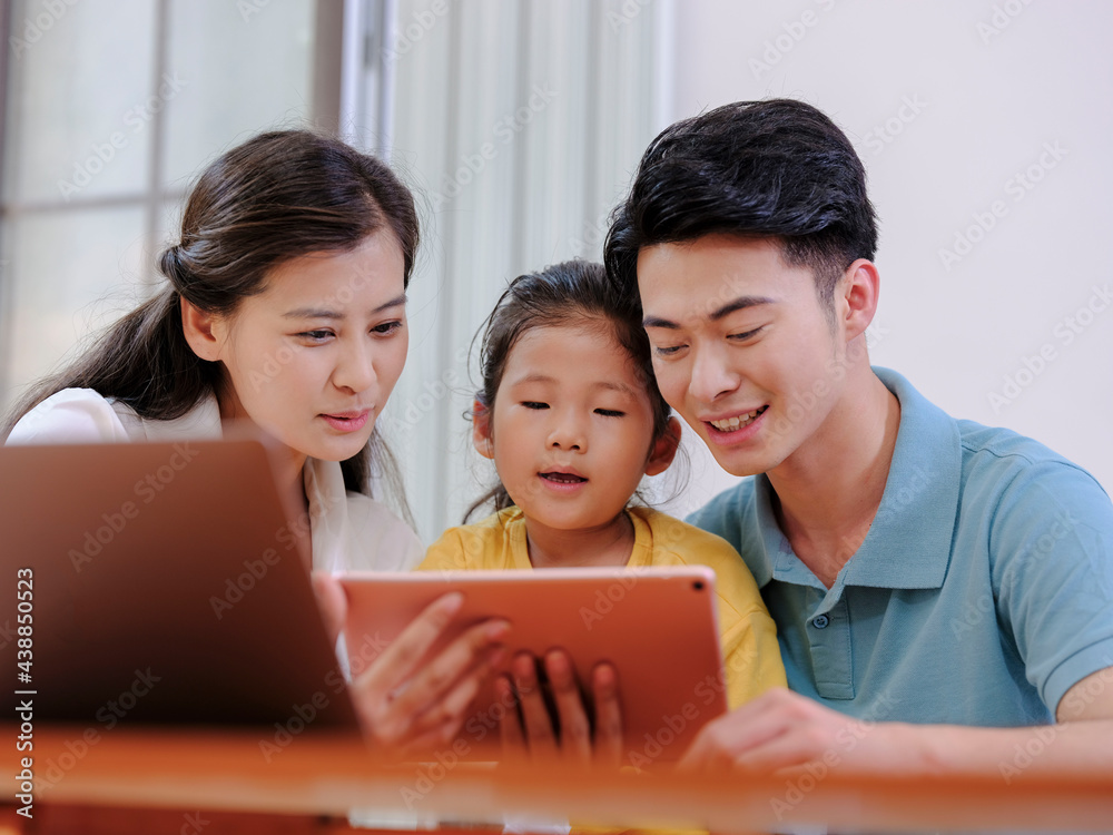 A Happy family of three using tablet