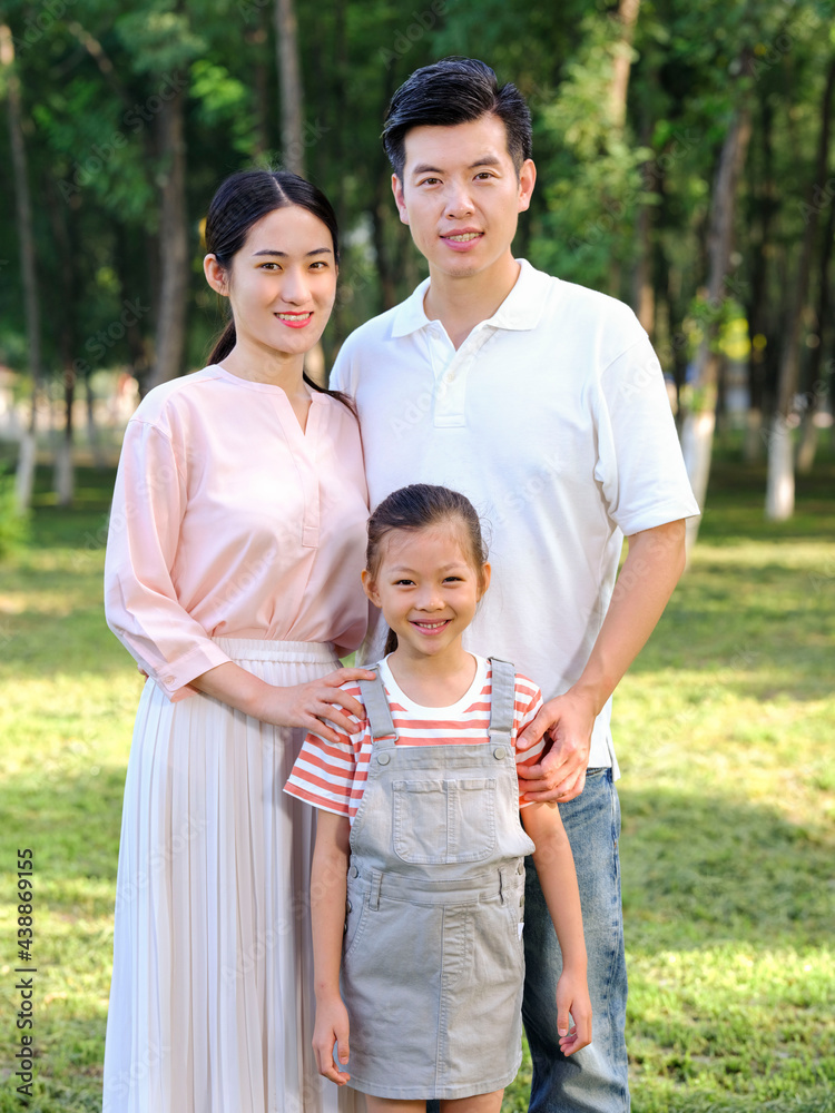 Happy family of three playing in the park