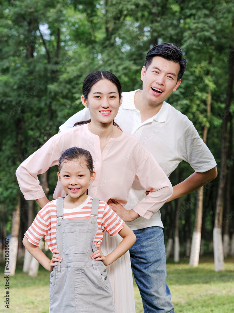 Happy family of three playing in the park