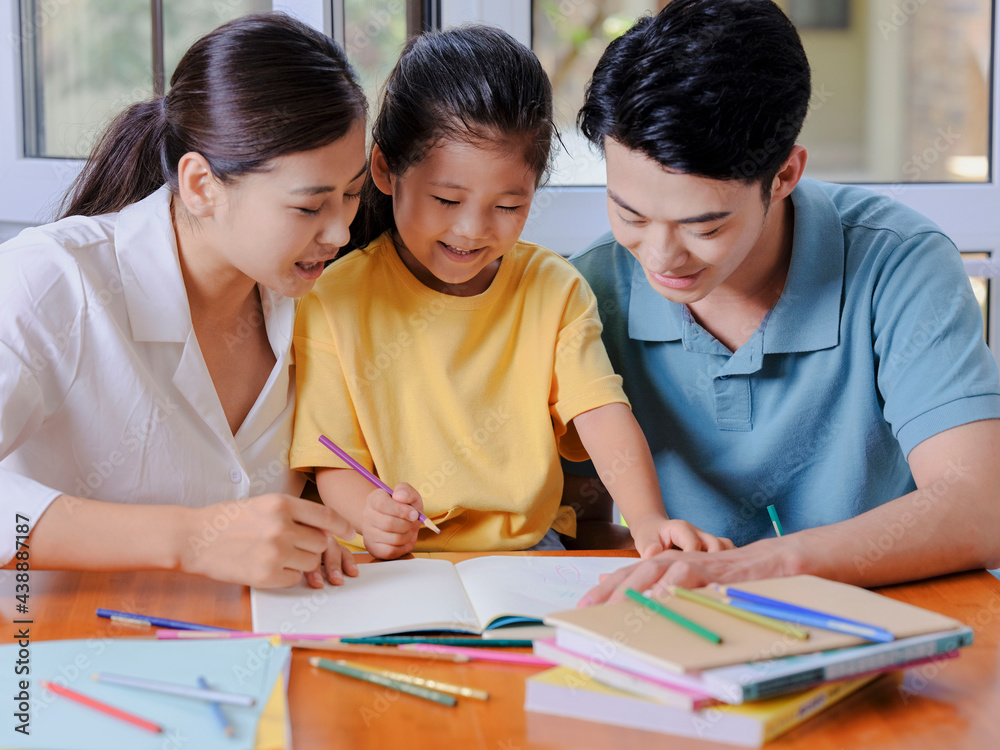 Young parents help their children with their homework