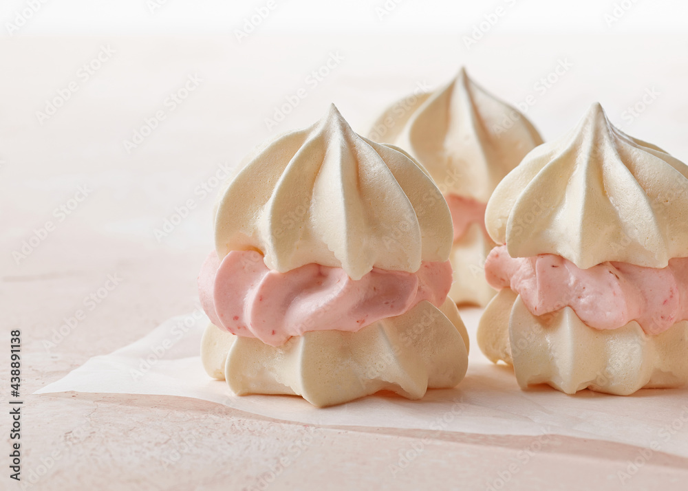 meringue cakes on pink background