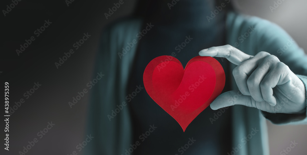 Love, Health Care, Donation and Charity Concept. Close up of Voluteer Holding a Heart Shape Paper