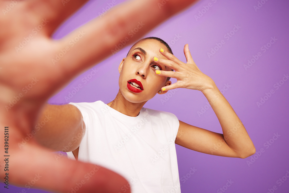 Attractive female model posing on purple background