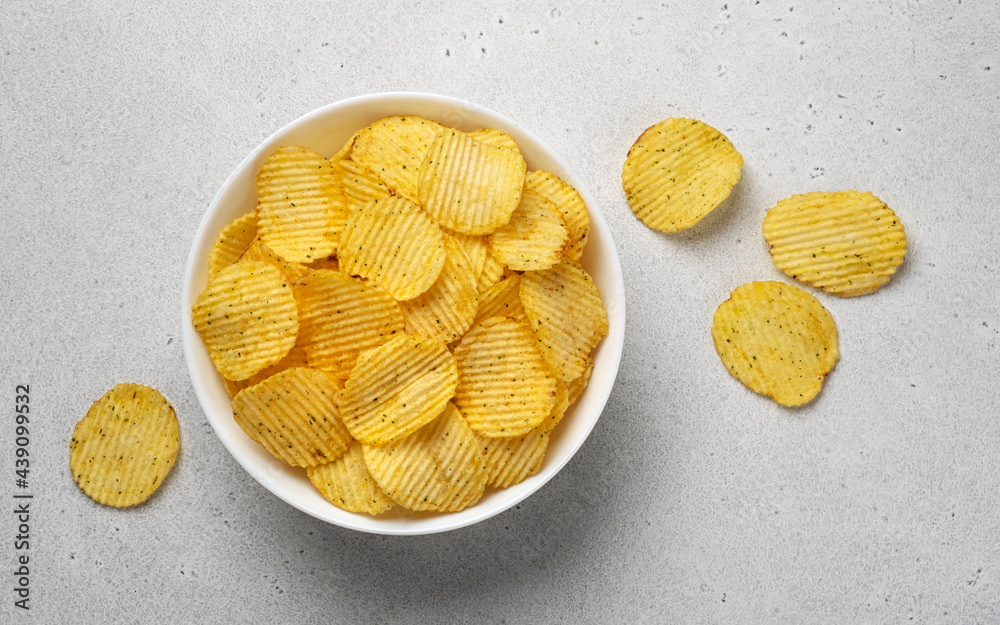 Ridged potato chips in bowl, top view