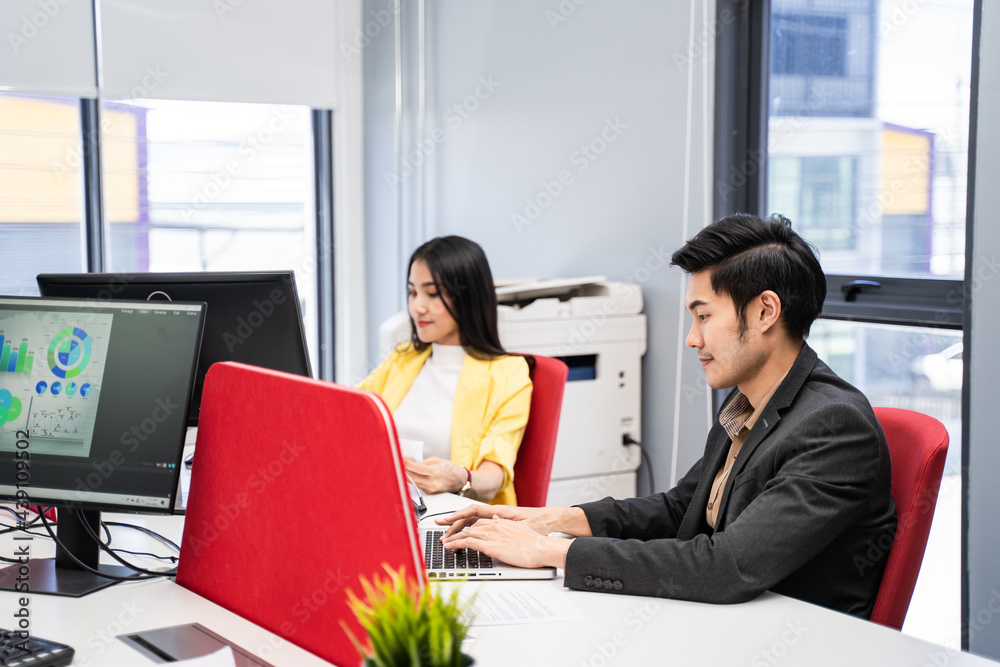 Asian Casual businesspeople typing on laptop computer, work in office.