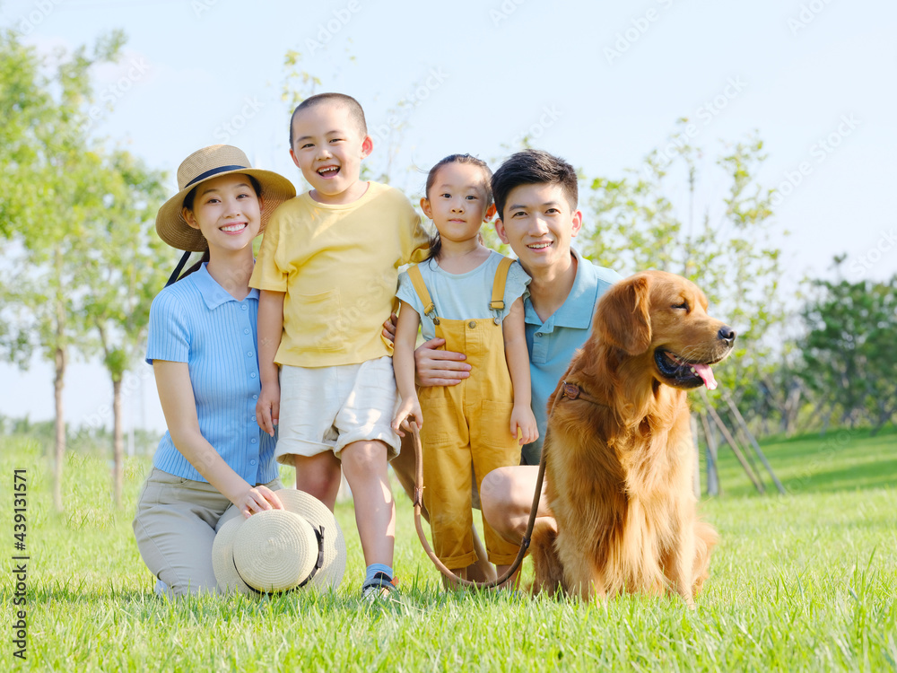 Happy family of four and pet dog in outdoor photo