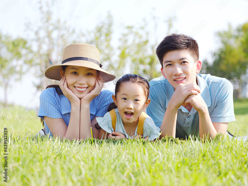 Happy family of three on the grass