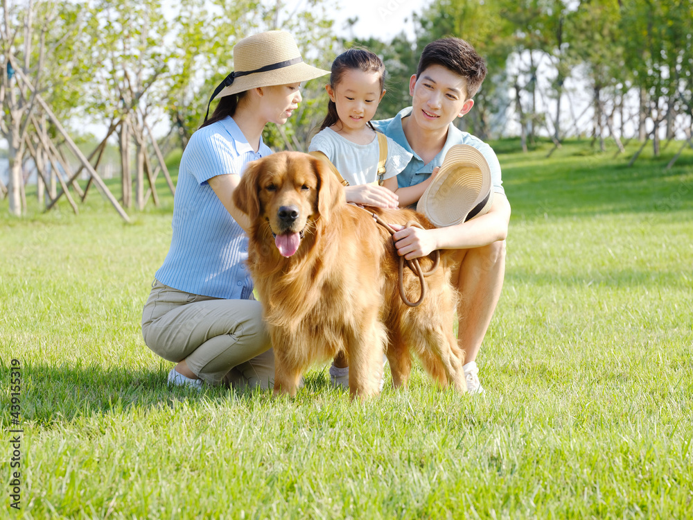 Happy family of three and pet dog in outdoor photo