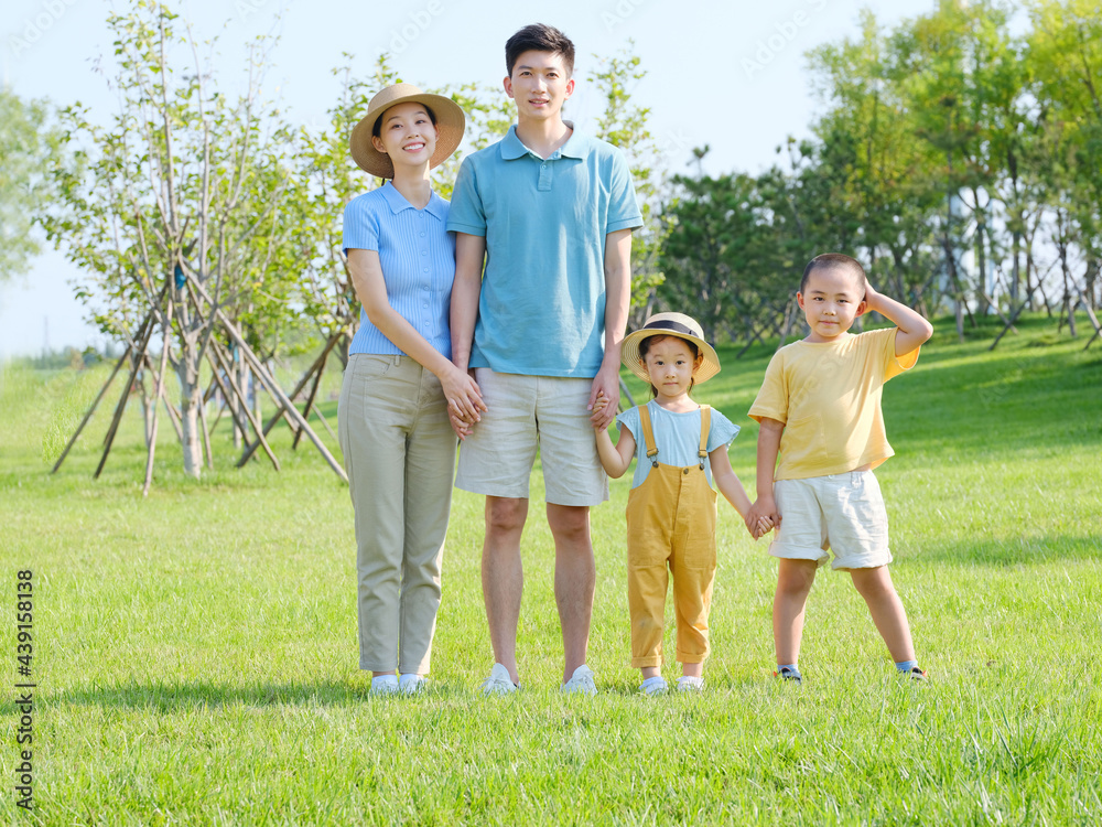 Happy family of four in the outdoor group photo