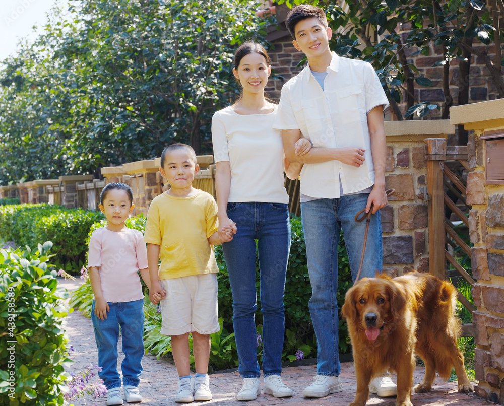 Happy family of four and pet dog in outdoor photo