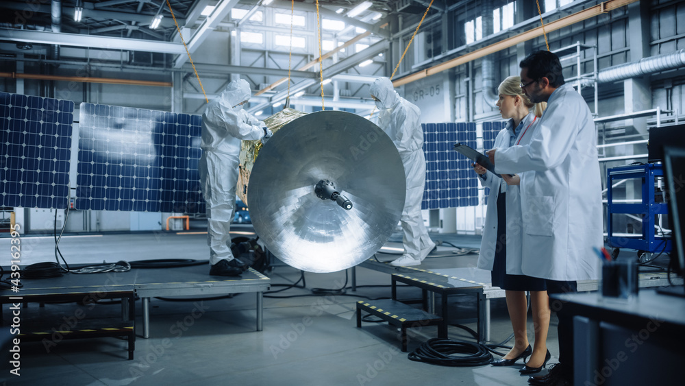 Team of Engineers Working on Satellite Construction, Use Tablet Computer Talk about Data. Aerospace 