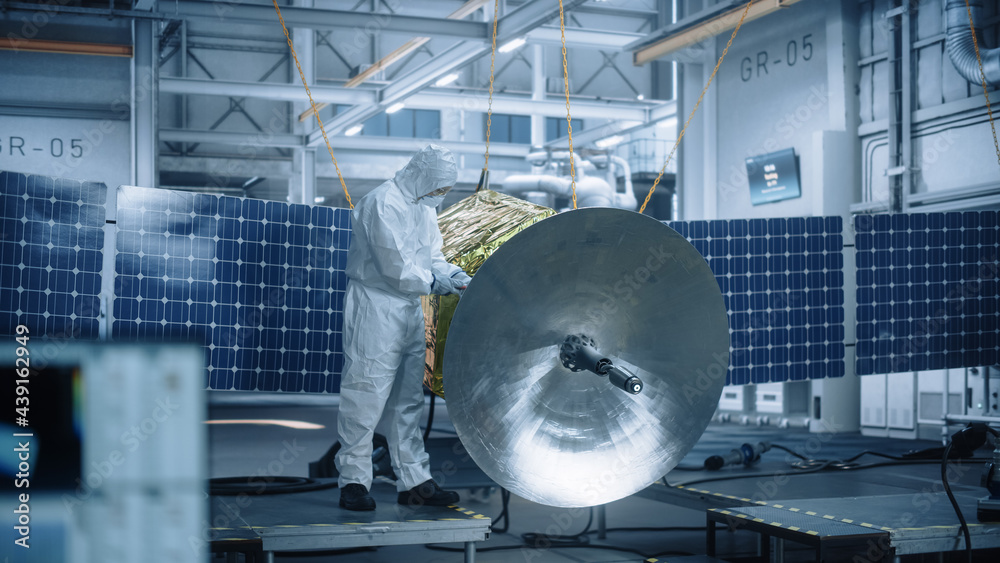 Engineer in Protective Suit Working on Satellite Construction. Aerospace Agency Manufacturing Facili