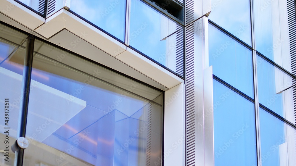 Glass and aluminum facade of a modern office building. View of futuristic architecture. Office build