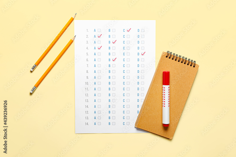 Answer sheet and stationery on color background