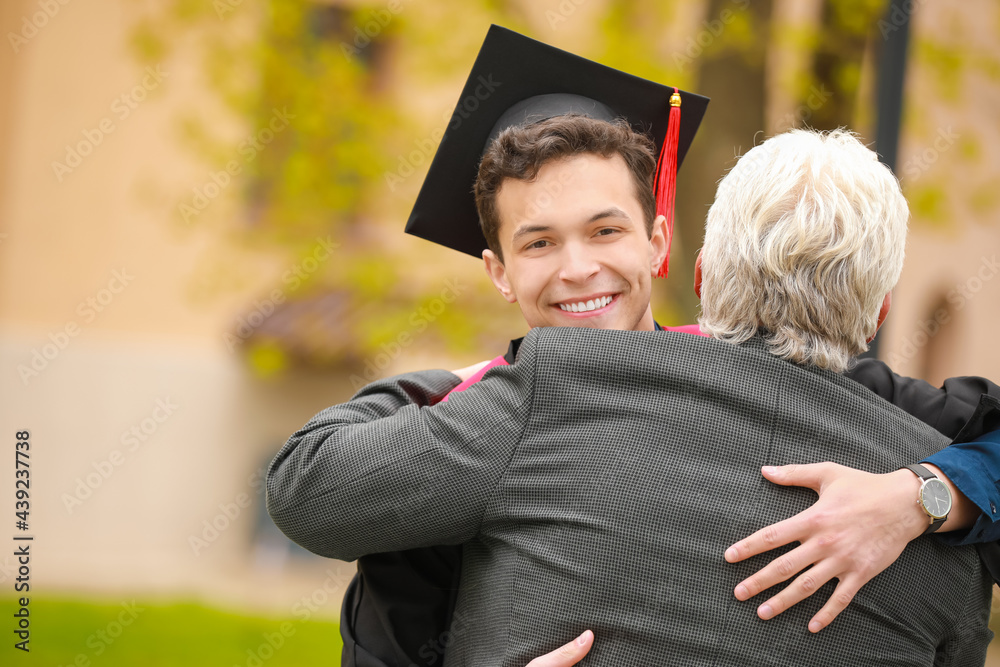 Happy young man with his father on graduation day