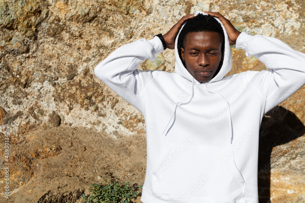 African American man in white hoodie posing outdoor photoshoot