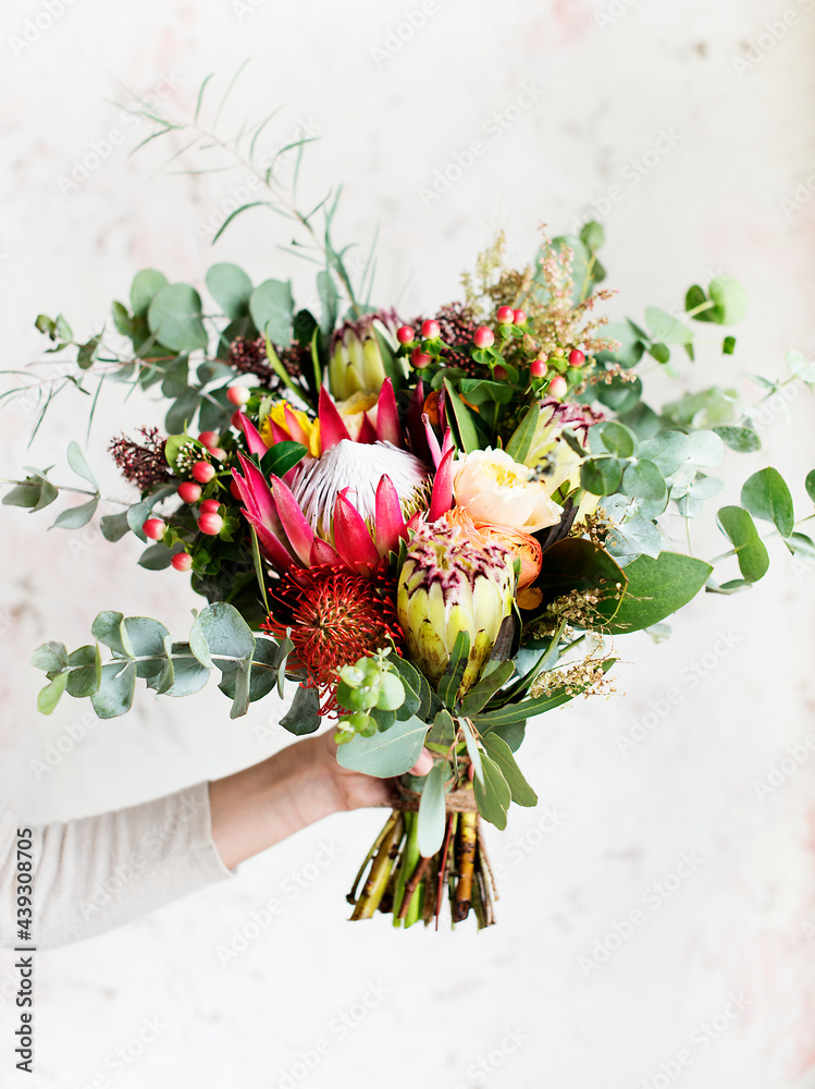 Hand holding beautiful bouquet of flowers