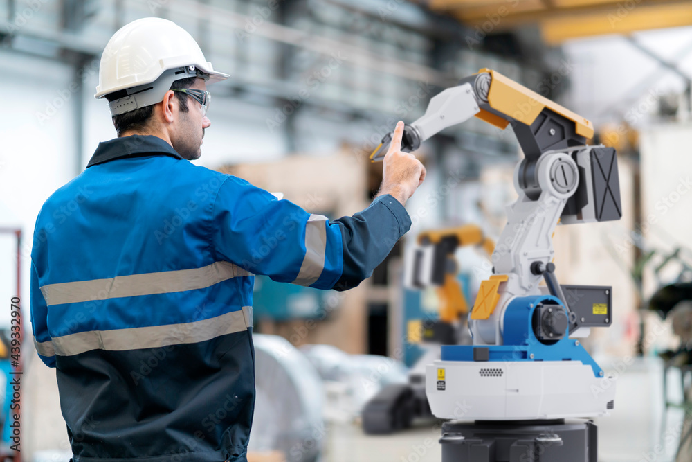 Engineer working with robot arm machine industrial 4.0 technology in factory. Futuristic innovation 