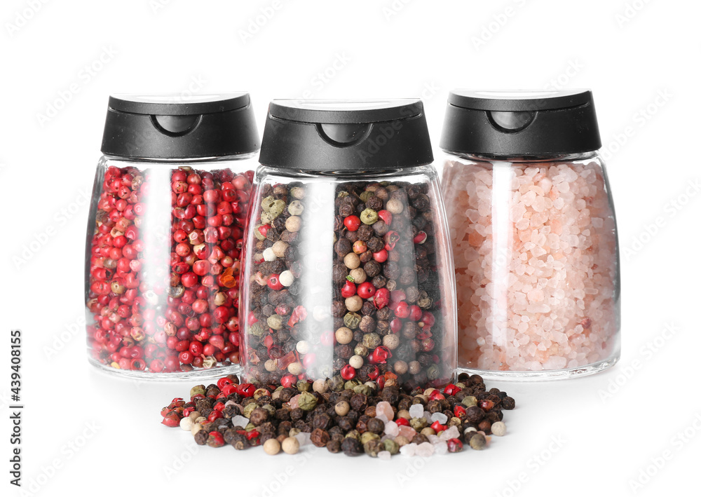 Jars with different spices on white background