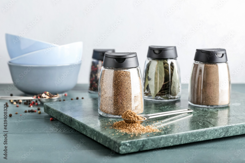 Jars with different spices on table