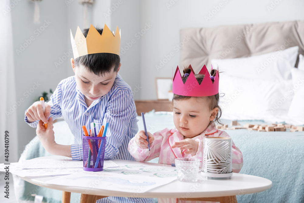 Cute little children drawing in bedroom