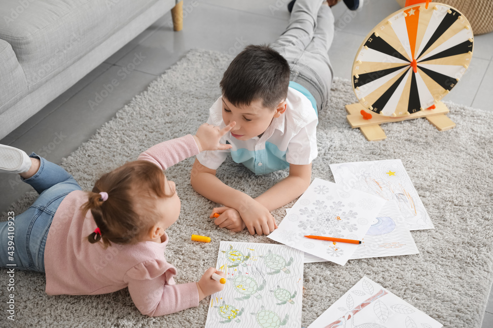 Cute little children drawing at home