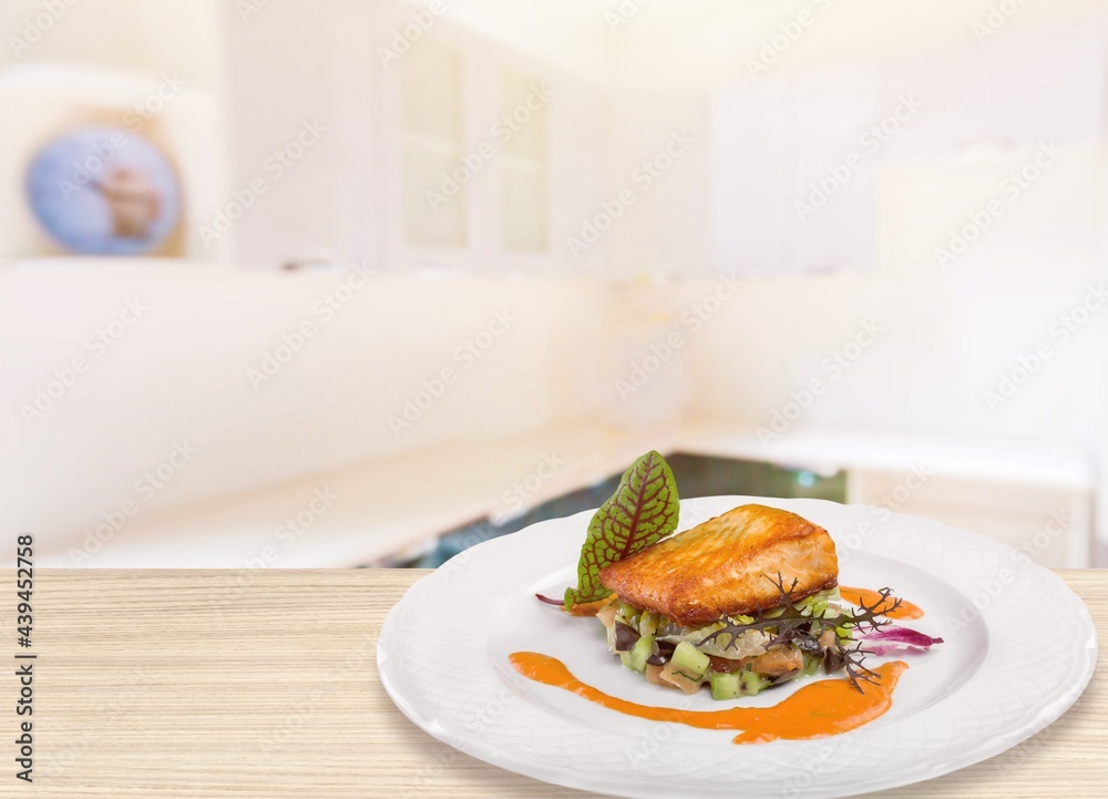 Freshly cooked salmon fillet on a white plate