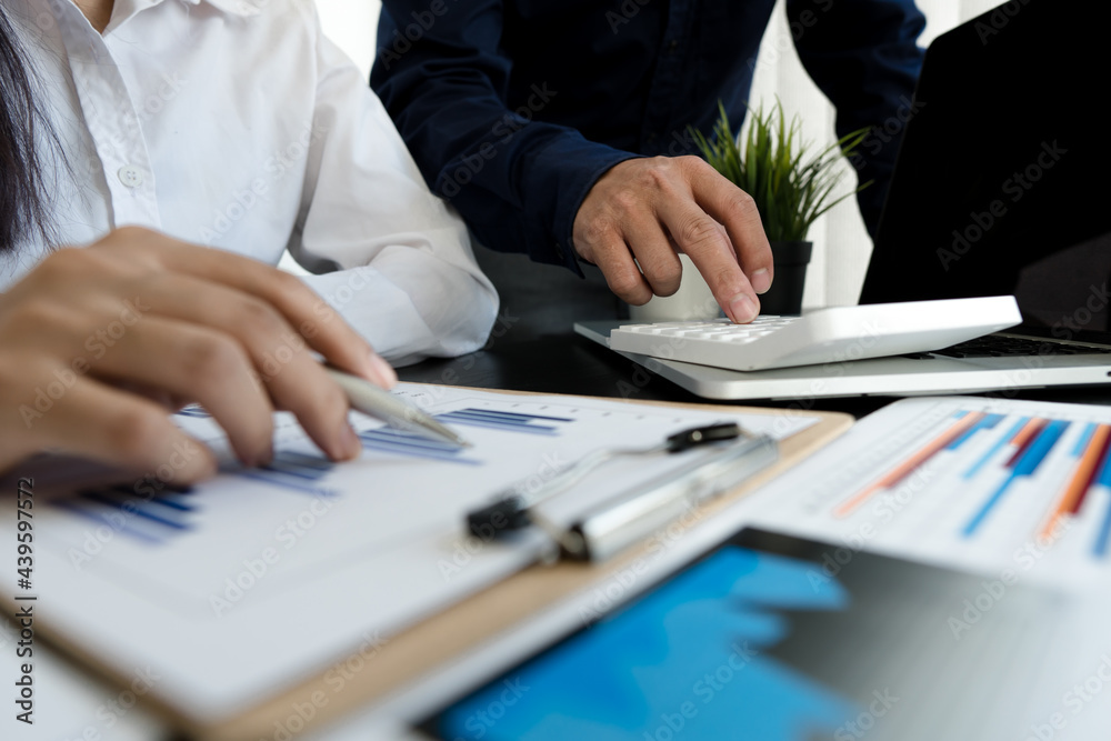 Teamwork with business people analysis cost graph on desk at meeting room.