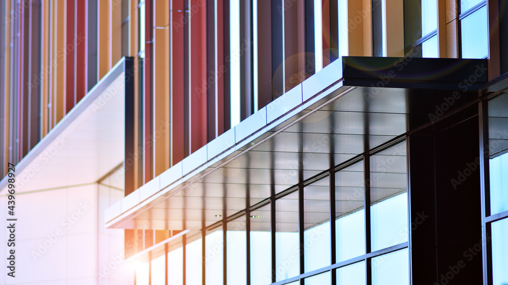 Reflection of modern commercial building on glass with sunlight. Geometric structure glass windows. 