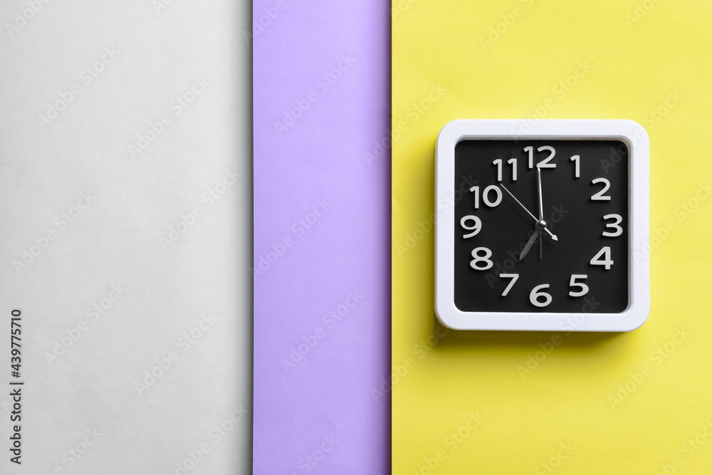 Stylish clock on color background