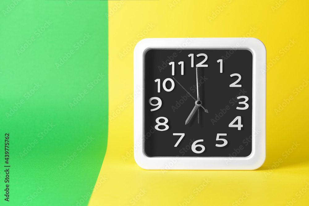 Stylish clock on color background