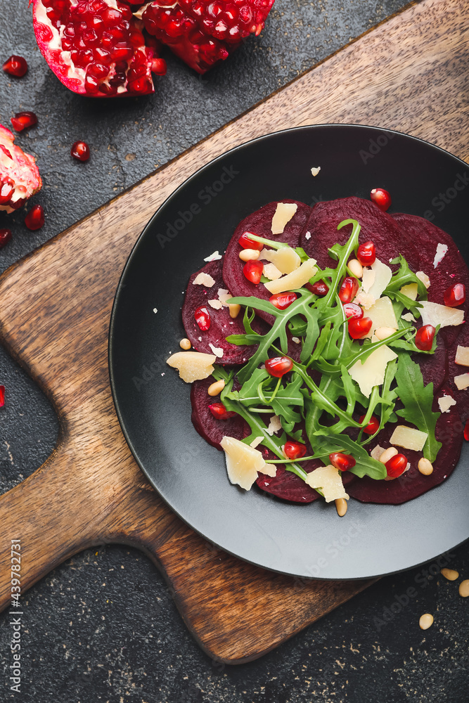 Plate with delicious beetroot carpaccio on dark background